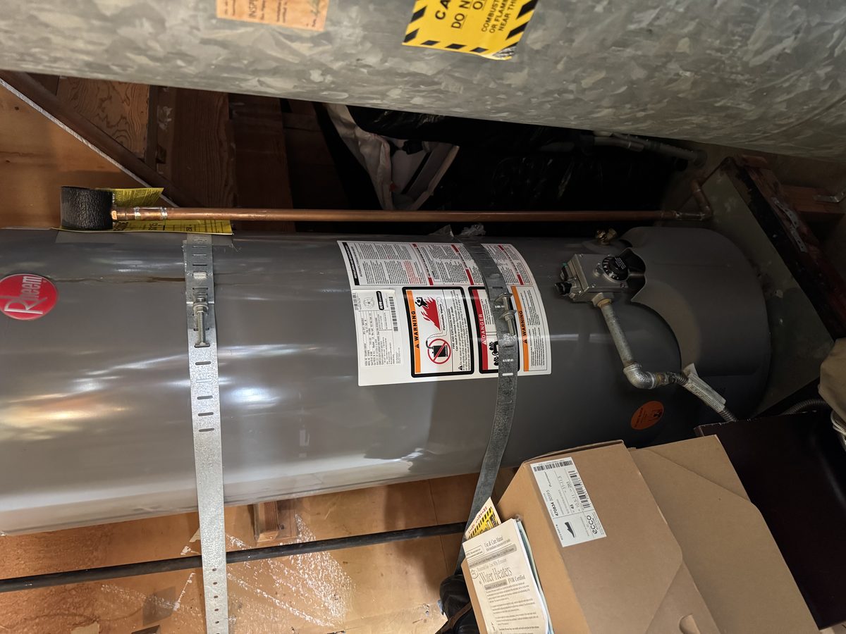 Licensed plumber installing AO Smith water heater