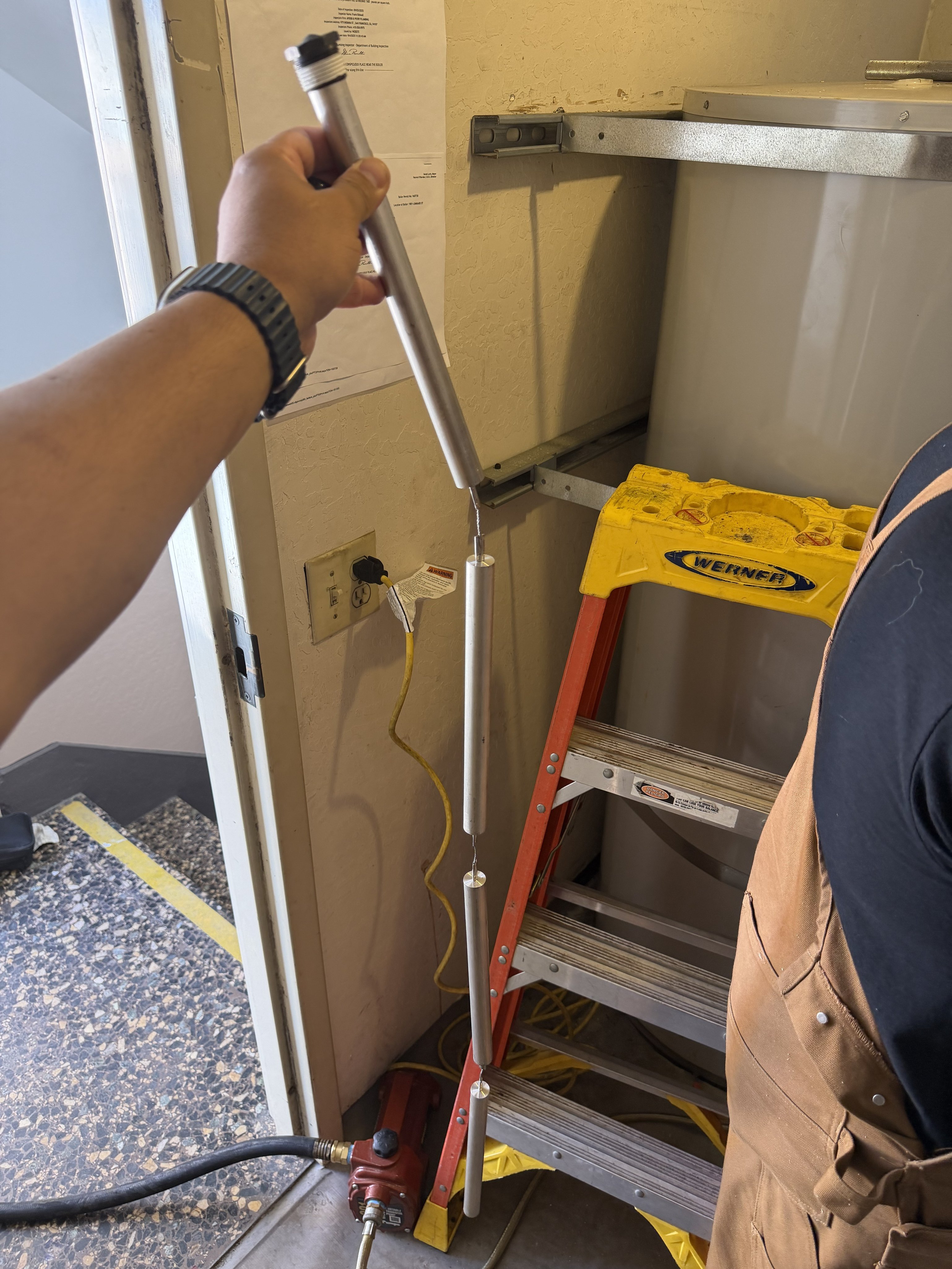 Technician inspecting cleanout and plumbing pipes in San Francisco