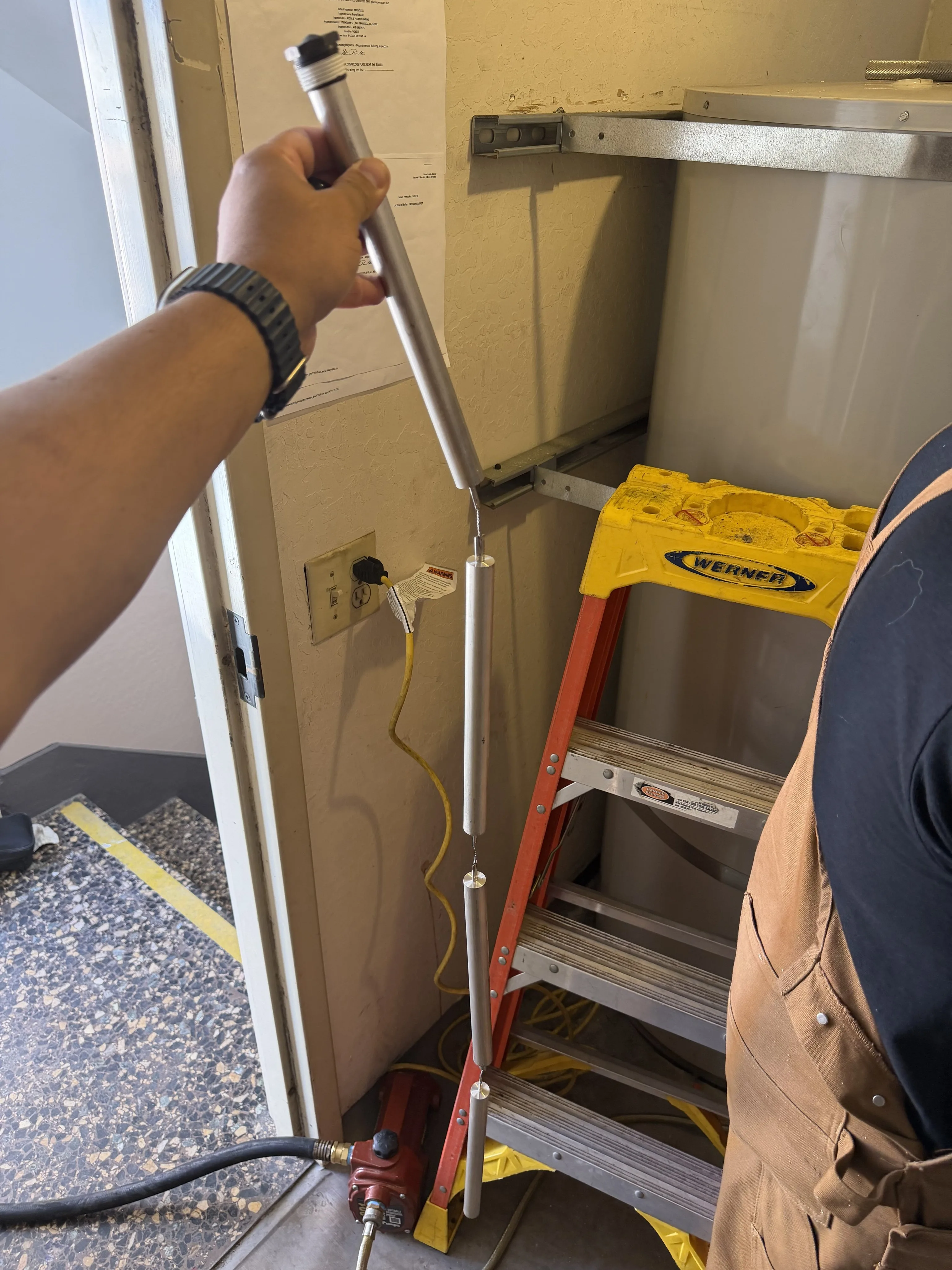 Technician inspecting cleanout and plumbing pipes in San Francisco