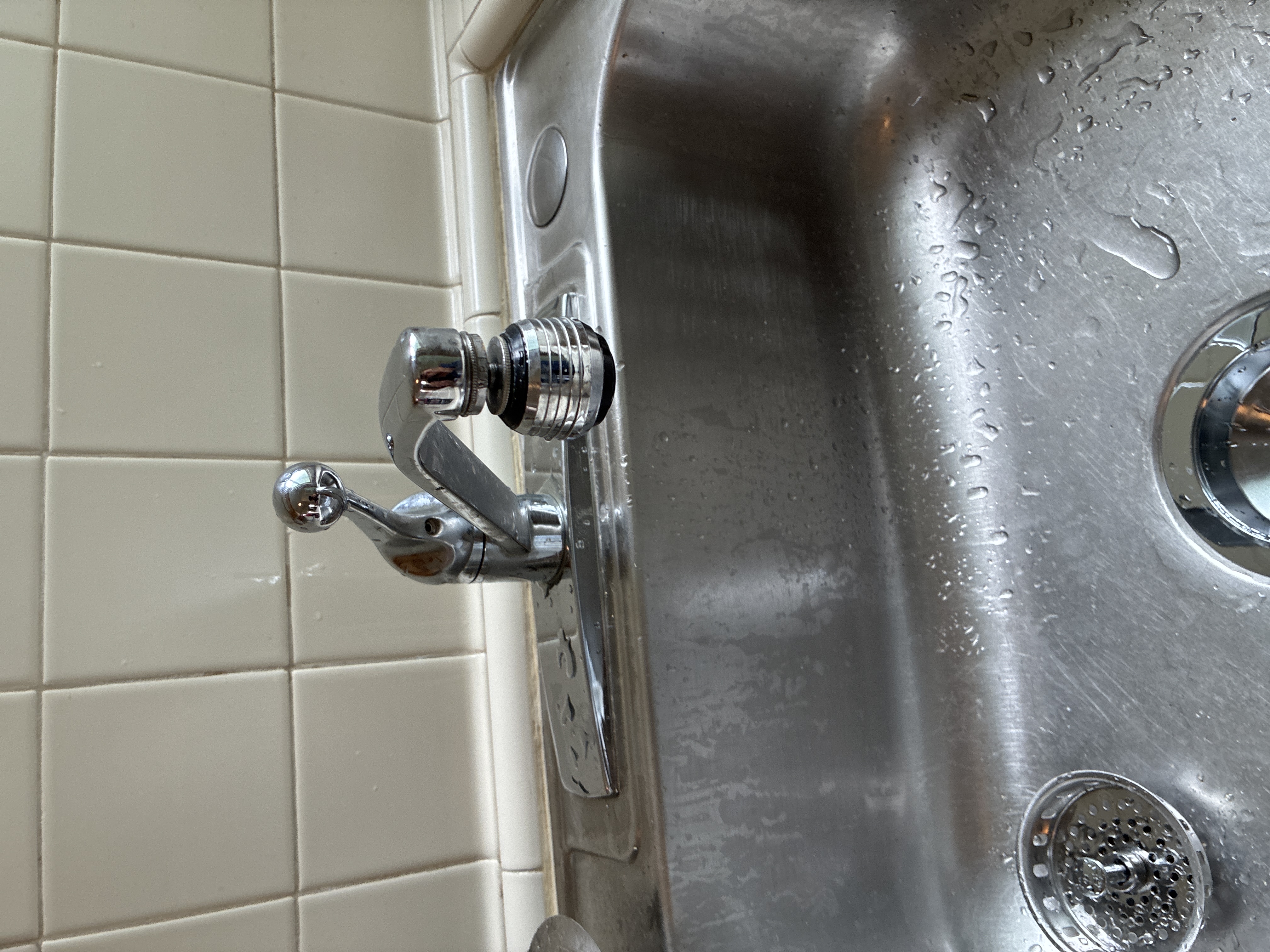 New basket strainer and drain pipe connections installed under bathroom basin sink