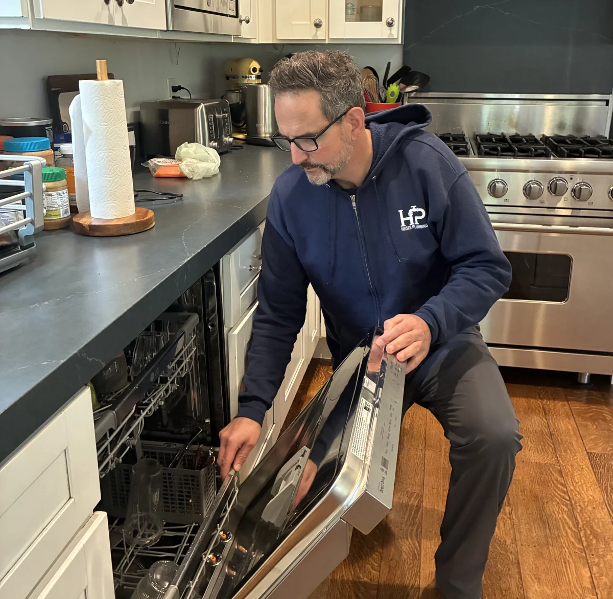 Heises Plumbing technician inspecting a dishwasher in San Francisco