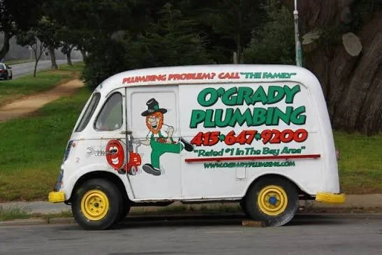 Classic vintage O'Grady Plumbing service van with leprechaun mascot logo